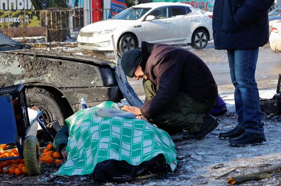 A man mourns his wife, who was killed while working at a food market following, what local Russian-installed authorities say, was a Ukrainian military strike in the course of Russia-Ukraine conflict in Donetsk, Russian-controlled Ukraine, January 21, 2024. REUTERS/Alexander Ermochenko Acquire Licensing Rights