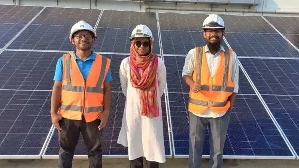 Farzana Akter Isha, a 24-year old engineer, poses before a rooftop solar plant along with her colleagues from SOLshare, Dhaka, Bangladesh, January 2024. Thomson Reuters Foundation