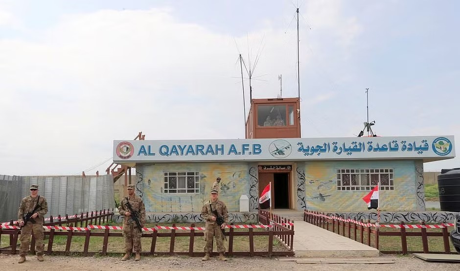 US soldiers stand guard during the hand over of Qayyarah Airfield West to Iraqi Security Forces, in the south of Mosul, Iraq March 26, 2020.