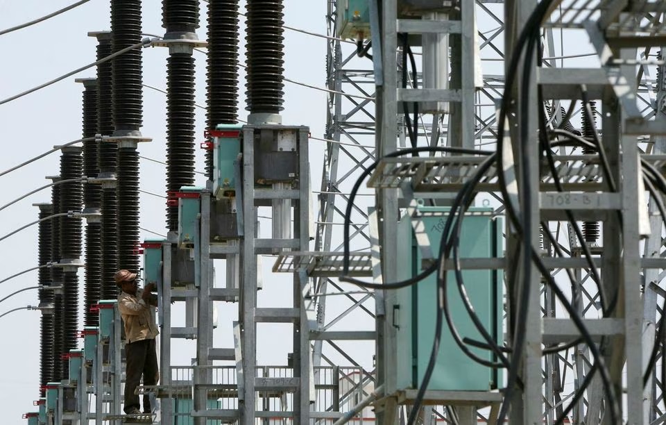 An employee works at the construction site of a grid power station in Jammu on May 5, 2011 — Reuters/Files