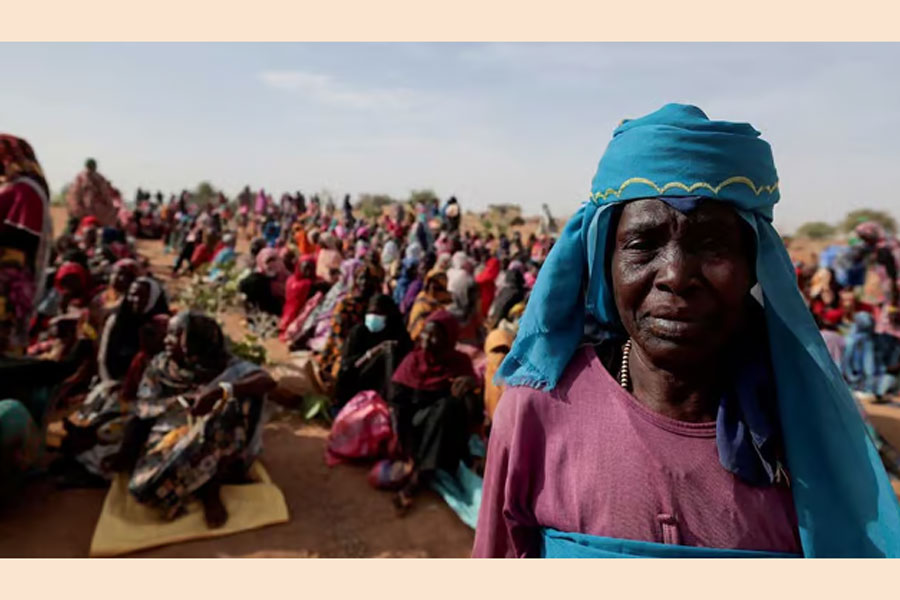 Halime Adam Moussa, a Sudanese refugee who is seeking refuge in Chad for a second time, waits with other refugees to receive a food portion from World Food Programme (WFP), near the border between Sudan and Chad in Koufroun, Chad, May 9, 2023.
