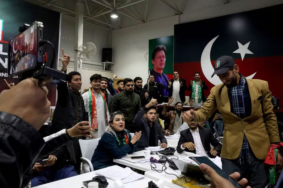 Pakistan Tehreek-e-Insaf (PTI) supporters watch the general election results at a PTI office in Islamabad, Pakistan February 8, 2024.
