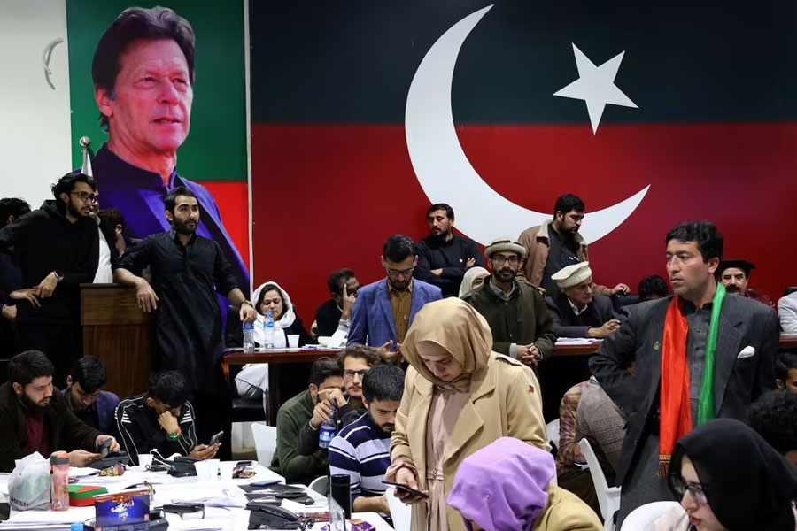 Volunteers for former Prime Minister Imran Khan’s party Pakistan Tehreek-e-Insaf (PTI) look on as they watch results on TV screens after the end of the polling during a general election at the party’s main office in Islamabad, Pakistan, February 8, 2024.