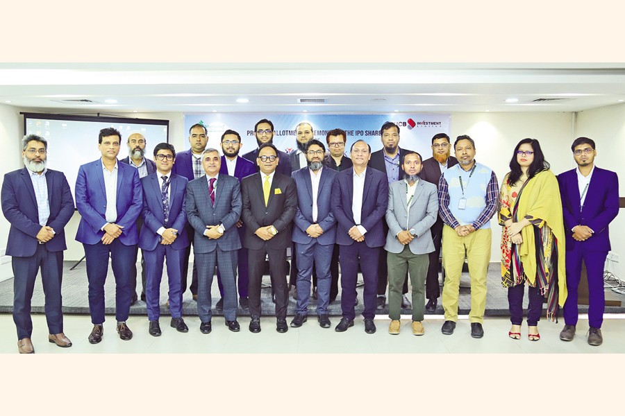 Dhaka Stock Exchange (DSE) Chief Regulatory Officer Khairul Bashar Abu Taher Mohammed, Chittagong Stock Exchange (CSE) Deputy General Manager Hasnine Bari, NRB Bank Deputy Managing Director Md. Shaheen Howlader and others pose for photos at a ceremony held at the DSE Tower in Dhaka on Tuesday marking the allocation of NRB Bank shares among general investors under the electronic subscription system.