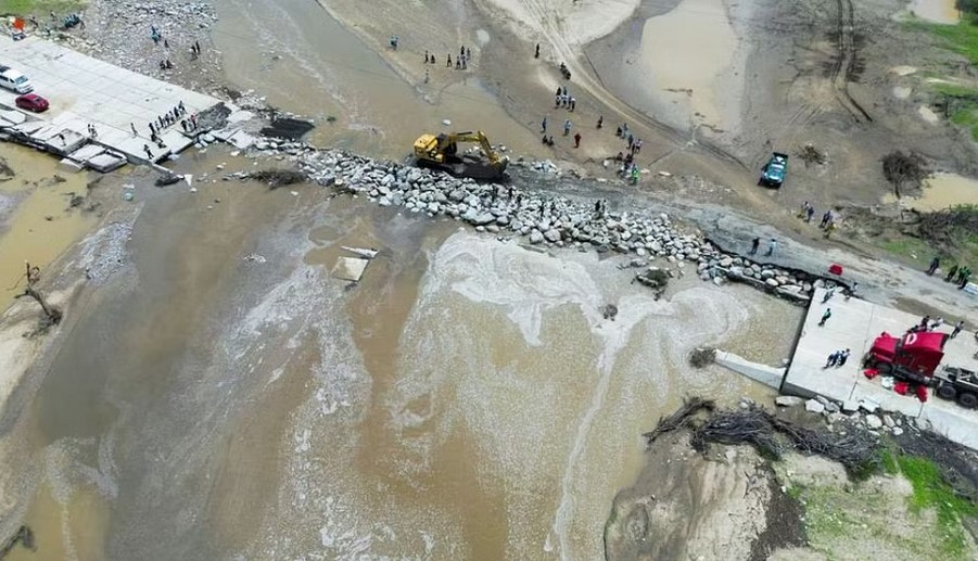 Machinery is used to repair a bridge destroyed by rains and floods caused by direct influence of Cyclone Yaku, in Piura, Peru, Mar 11, 2023. REUTERS