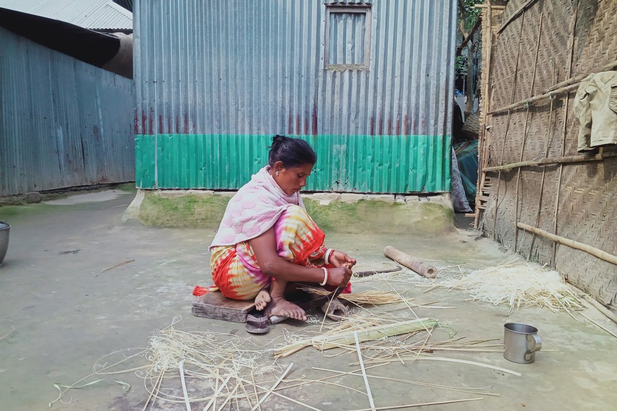 A female workers busy processing bamboos at Rifaitpur Patnipara village of Gaibandha Sadar Upazila to make household items