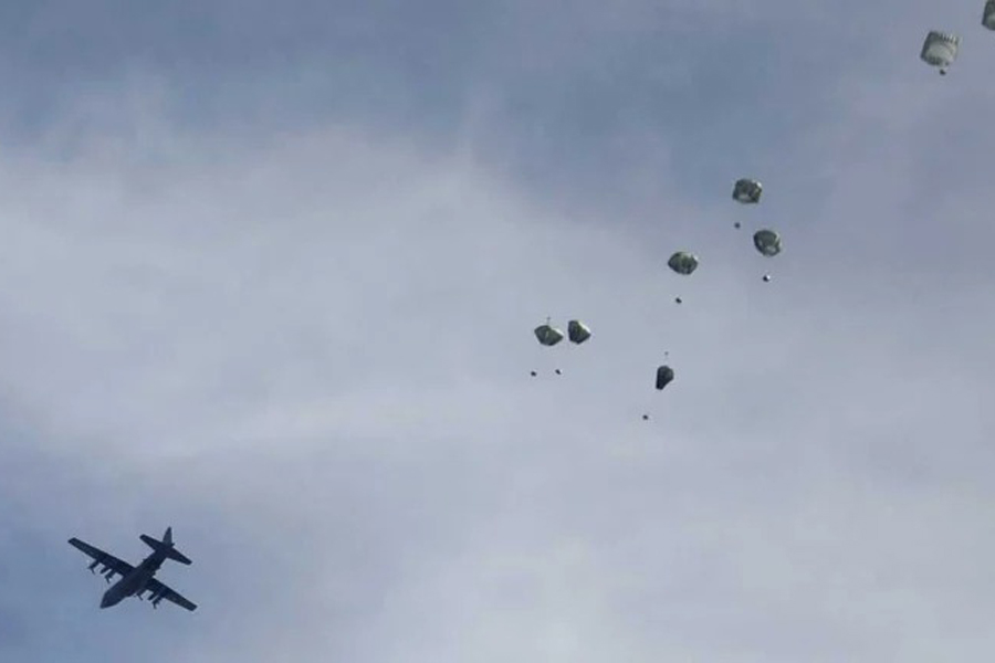 A plane drops aid over Gaza, amid the ongoing conflict between Israel and Hamas, in Gaza City, March 1, 2024.Reuters/Files