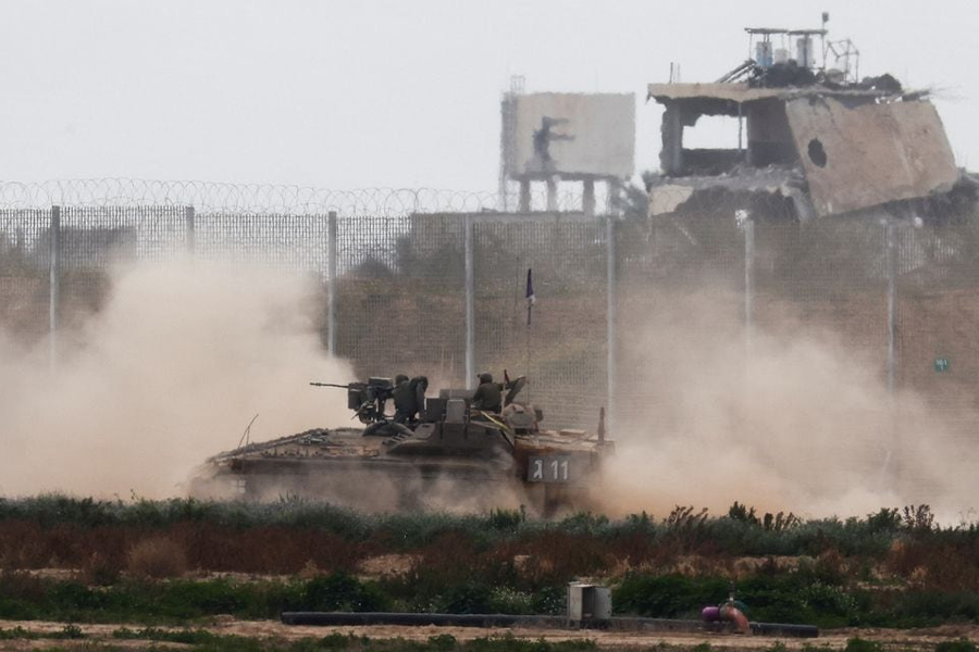 An Israeli armoured personnel carrier (APC) maneuvers along the Israel-Gaza border fence, amid the ongoing conflict between Israel and the Palestinian Islamist group Hamas, as seen from southern Israel, Israel March 3, 2024.