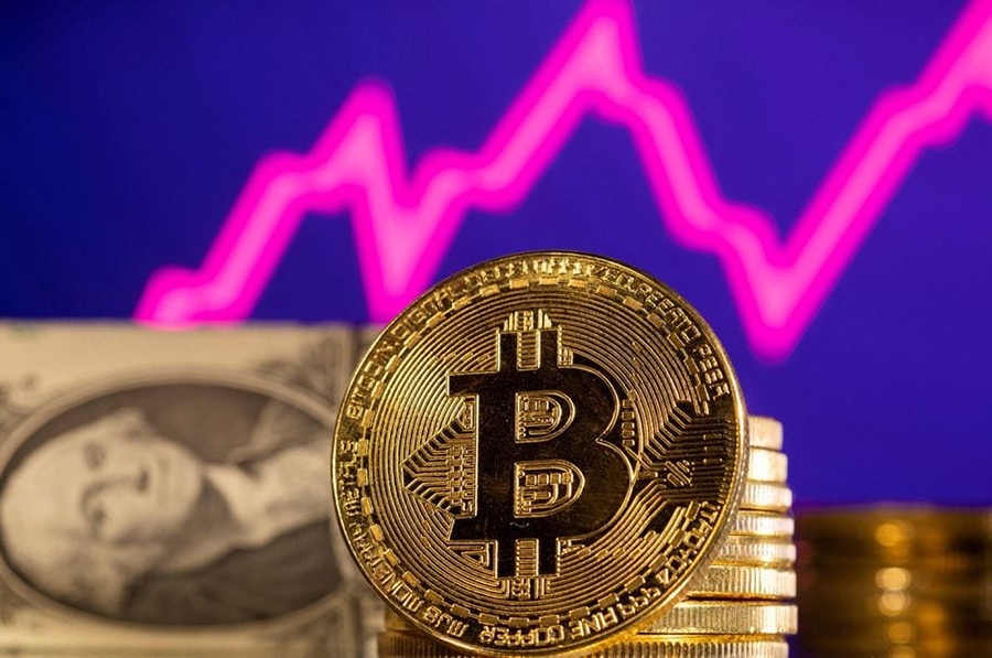 A representation of bitcoin is seen in front of a stock graph and US dollar in this illustration taken on January 24, 2022 — Reuters/Files