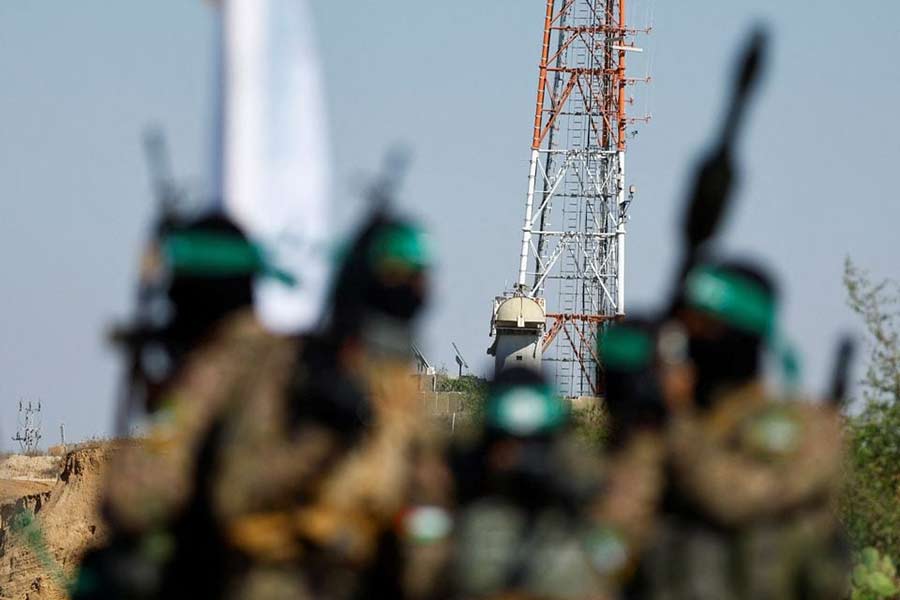 Palestinian fighters from the armed wing of Hamas taking part in a military parade in front of an Israeli military site to mark the anniversary of the 2014 war with Israel, near the border in the central Gaza Strip, July 19, 2023 –Reuters file photo