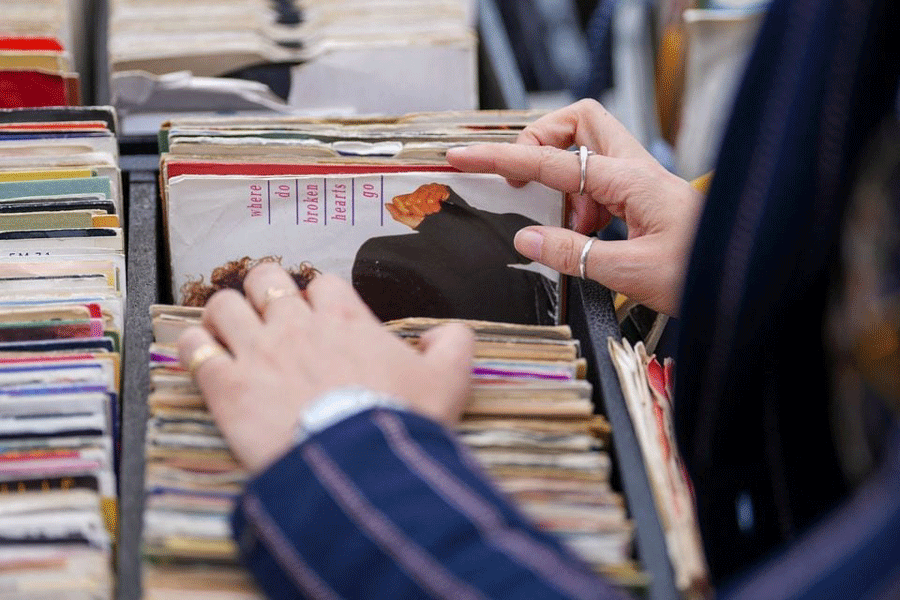 A person browses vinyl records at a Classic Car Boot Sale in Kings Cross alongside designer-makers, street food and classic vehicles, in London, Britain April 15, 2023.