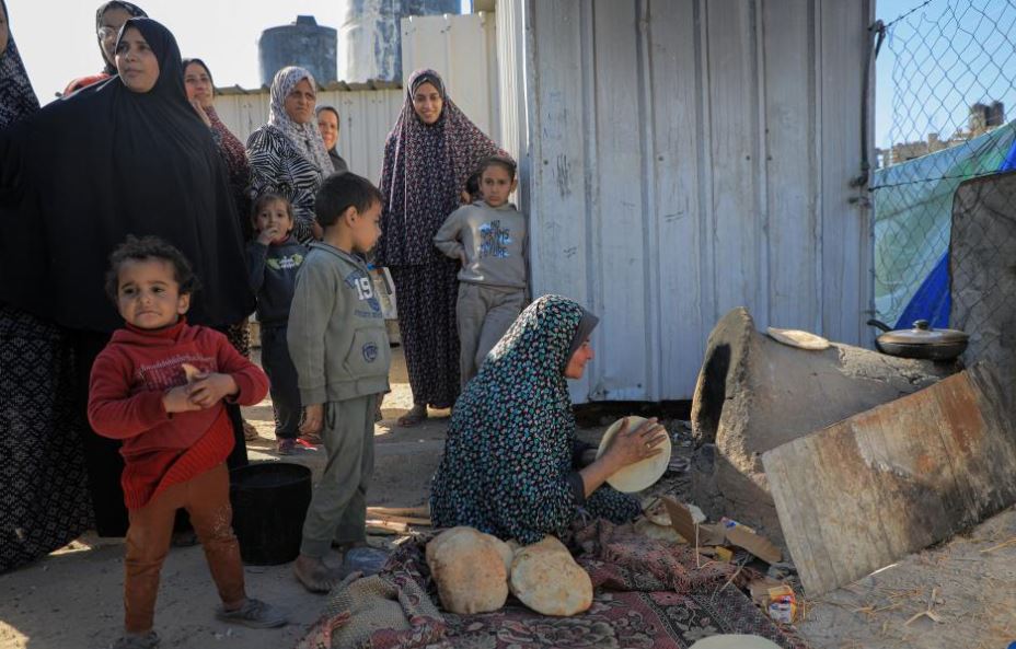 A woman makes bread at a temporary camp in the southern Gaza Strip city of Rafah, on March 8, 2024—Xinhua Photo