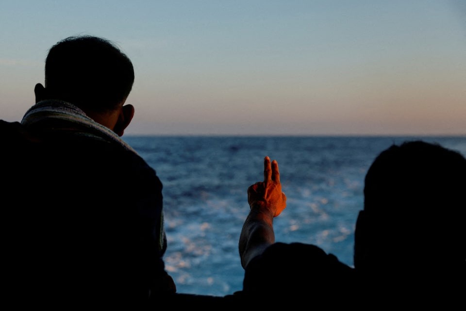 A migrant gestures on the Geo Barents migrant rescue ship, operated by Medecins Sans Frontieres (Doctors Without Borders), as it makes its way to Italy after the rescue of 61 migrants on a wooden boat in international waters off the coast of Libya in the central Mediterranean Sea on September 30, 2023 — Reuters/Files
