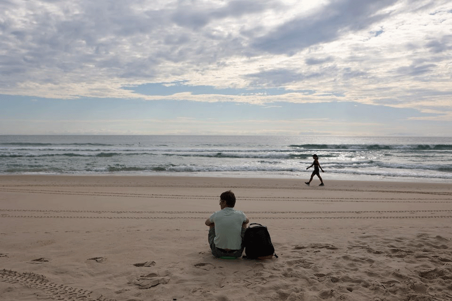 Ivan Ivanov, 34, sits at the beach before he starts work, in Florianopolis where he has been living for eight years after leaving his hometown of Tomsk in Russia, Brazil, February 23, 2024.