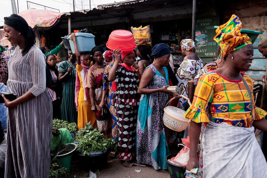 Women shop at a street market ahead of the presidential election in Banjul, Gambia, December 3, 2021.