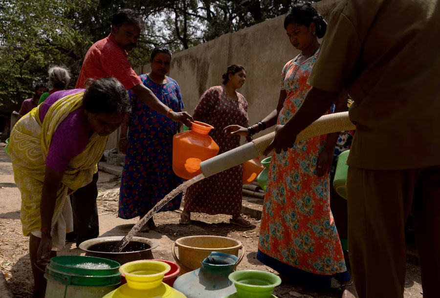 Residents get their containers filled with drinking water from a water tanker supplied by Bruhat Bengaluru Mahanagara Palike (BBMP) in a neighbourhood that is facing severe water scarcity, in the south of Bengaluru, India, March 11, 2024.