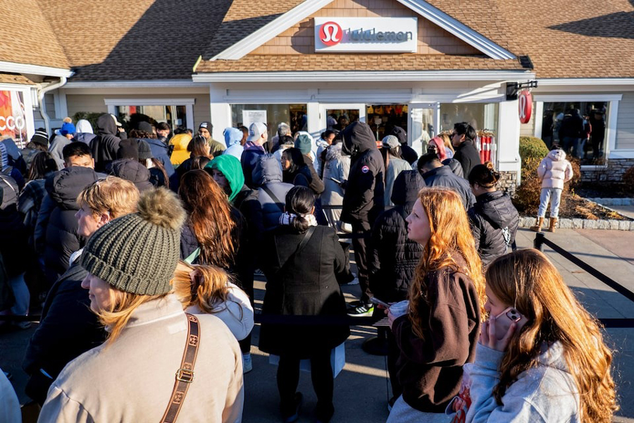 Black Friday shoppers stand in line for a Lululemon store as retailers compete to attract shoppers and try to maintain margins on Black Friday, one of the busiest shopping days of the year, at Woodbury Common Premium Outlets in Central Valley, New York, US, November 24, 2023.