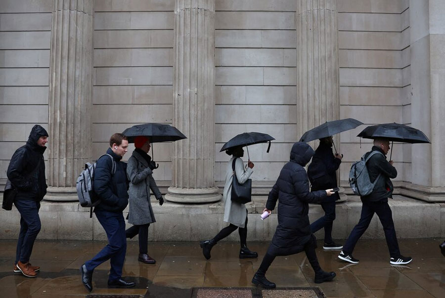 Commuters walk during the morning rush hour near the Bank of England in the City of London financial district in London, Britain, February 8, 2024.