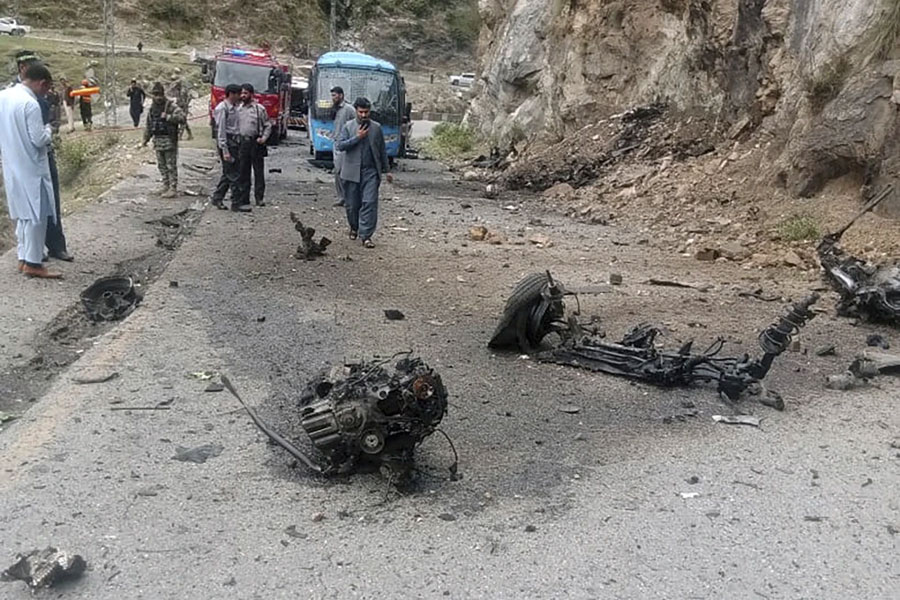 Police officers examine the site of suicide bombing at a highway in Shangla, district in the Pakistan’s Khyber Pakhtunkhwa province, Tuesday, March 26, 2024. A suicide bomber in northwest Pakistan has rammed his explosive-laden car into a vehicle on Tuesday, killing five Chinese nationals and their Pakistani driver, police and government officials said.