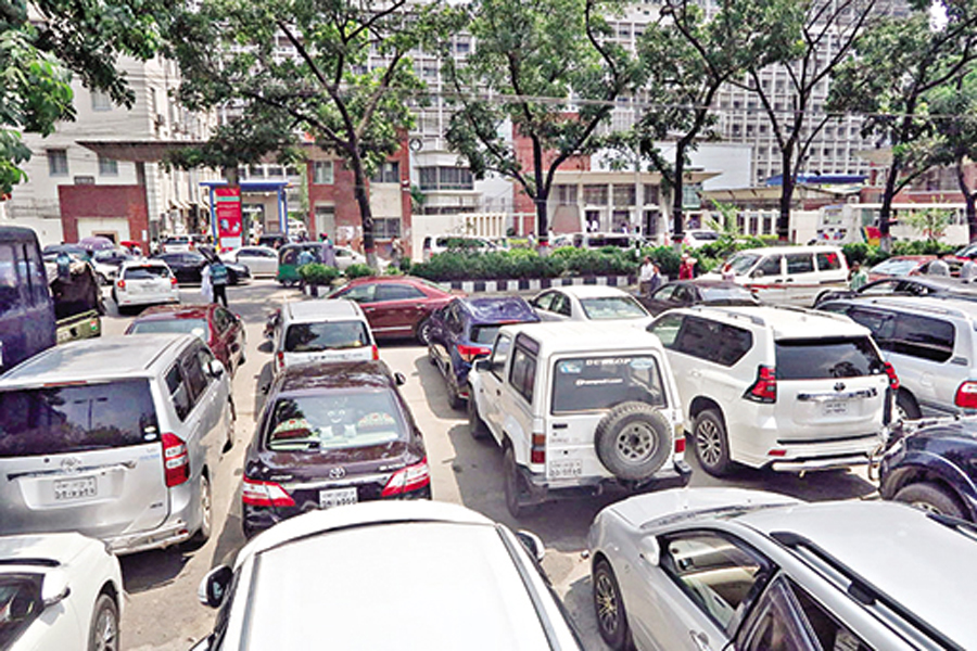 Vehicles parked occupying a part of Abdul Gani Road in Dhaka.