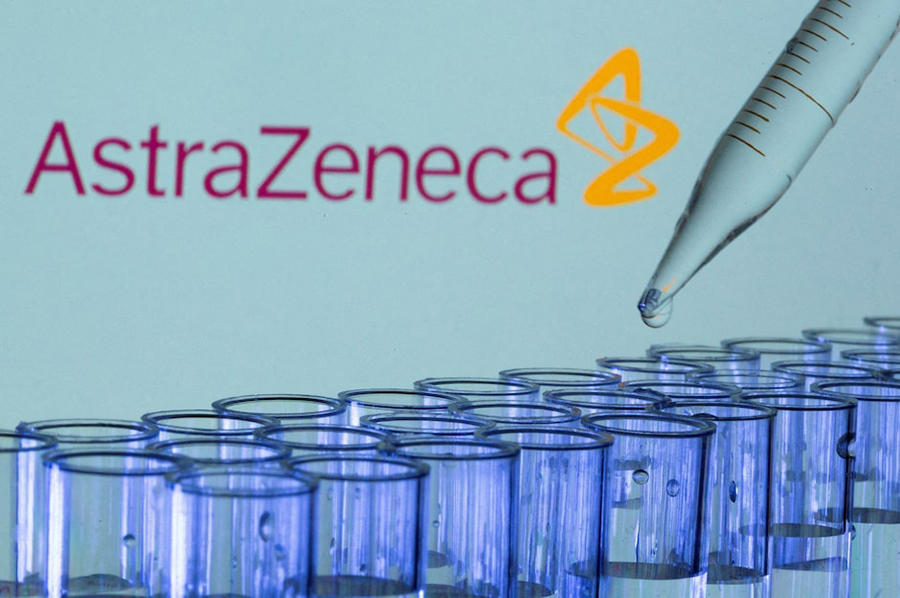 Test tubes are seen in front of a displayed AstraZeneca logo in this illustration taken on May 21, 2021 — Reuters illustration/File