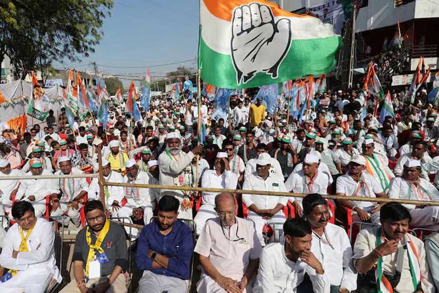 A supporter of Rahul Gandhi, a senior leader of India’s main opposition Congress party, waves a party flag in a public meeting during Rahul’s 66-day long “Bharat Jodo Nyay Yatra”, or Unite India Justice March, in Jhalod town, Gujarat state, India, March 7, 2024.