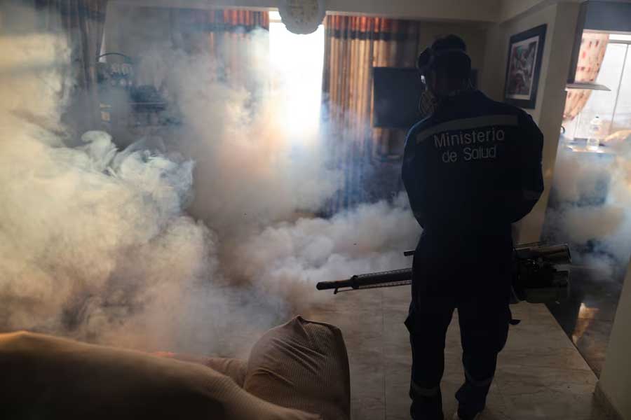 A Ministry of Health worker sprays insecticide to prevent dengue in a house in Lima, Peru, March 7, 2024.