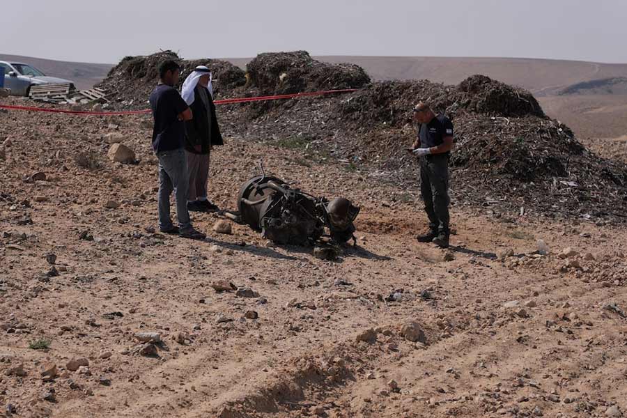 A police officer and residents inspecting the remains of a rocket booster that, according to Israeli authorities critically injured a 7-year-old girl, after Iran launched drones and missiles towards Israel, near Arad, Israel, on Sunday –Reuters photo