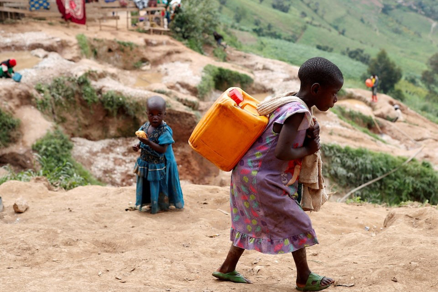 A girl carries a container of water at a coltan mine in Kamatare, Masisi territory, North Kivu Province of Democratic Republic of Congo, December 1, 2018.