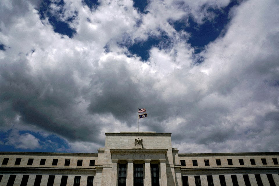 Flags fly over the Federal Reserve building on a windy day in Washington, US, May 26, 2017.