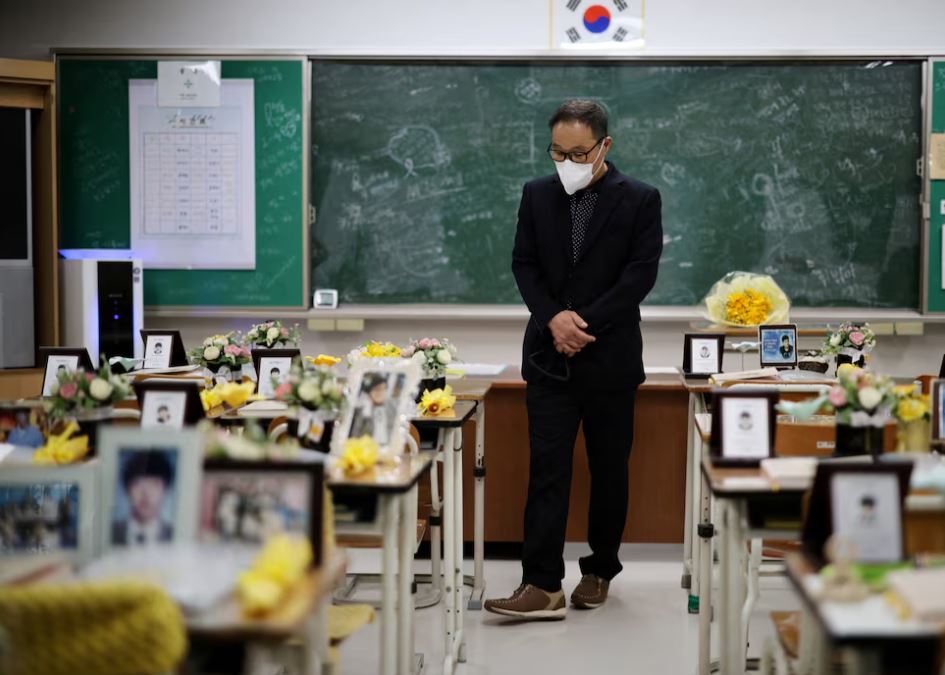 A man takes a look around a replicated classroom of students who died in the sunken Sewol ferry disaster that killed 304 people, mostly school students, in Ansan, South Korea. REUTERS/Kim Hong-Ji