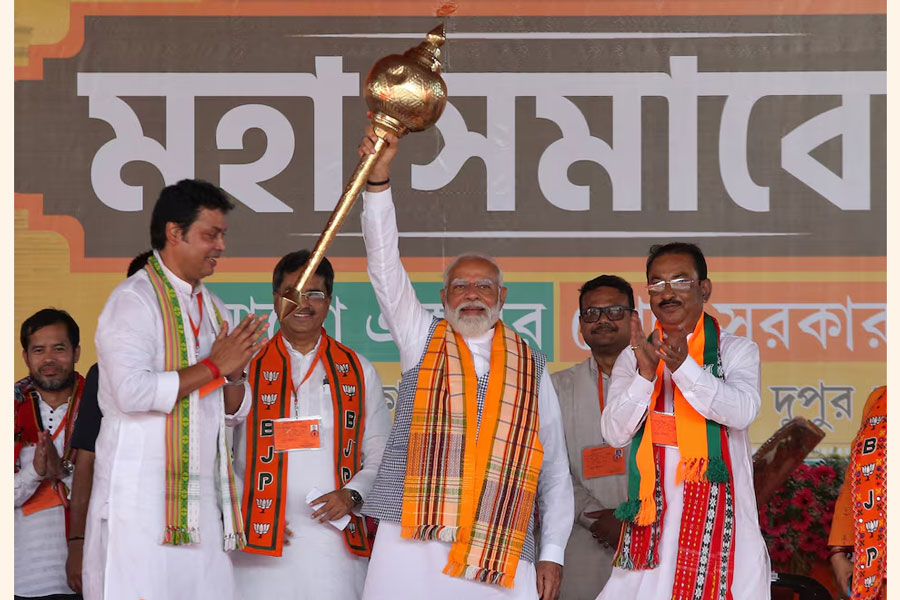 India's Prime Minister Narendra Modi holds up a mace during an election campaign rally in Agartala, India, April 17, 2024.