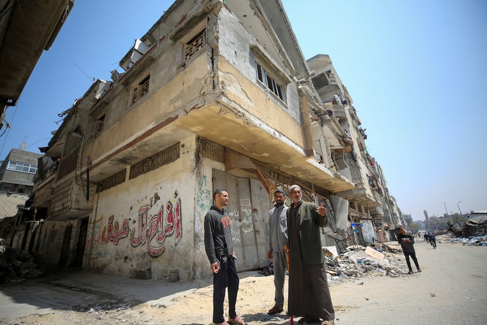 Ali, the grandfather, and Mahmoud, the father of Palestinian boy Zein Oroq, who was wounded after he was hit by aid airdropped on Gaza and later succumbed to his wounds, stand near their house which was hit in an Israeli strike, amid the ongoing conflict between Israel and the Palestinian Islamist group Hamas, in Gaza City on April 16, 2024 — Reuters photo