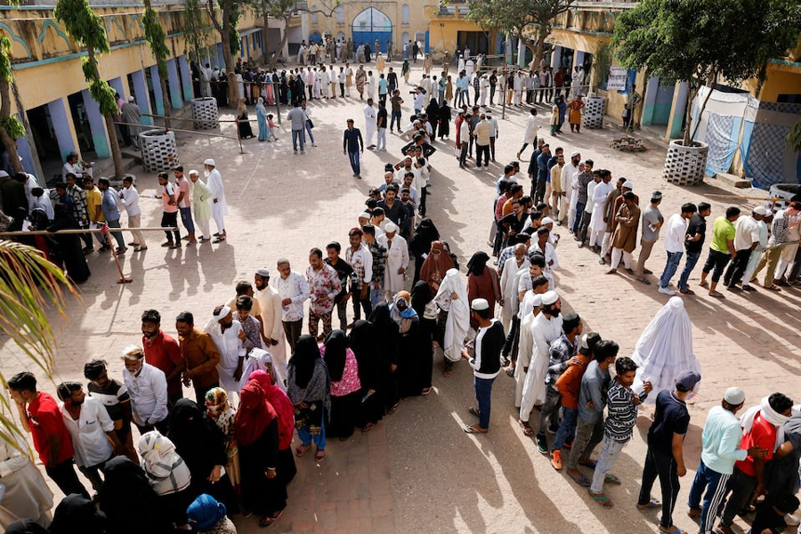 Voters line up outside a polling station to vote during the first phase of the general election in Kairana, in the northern Indian state of Uttar Pradesh, India, April 19, 2024.