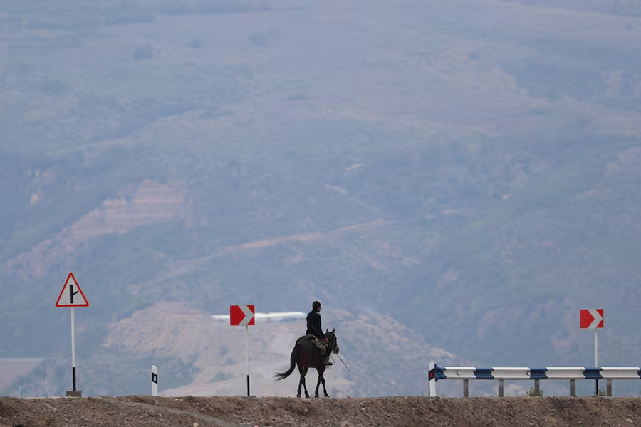 A man rides a horse along a road near the Armenia-Azerbaijan border outside the village of Kornidzor, Armenia, September 23, 2023.