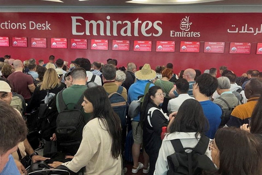 People queue at a flight connection desk after a rainstorm hit Dubai, causing delays at the Dubai International Airport, United Arab Emirates, April 17, 2024.
