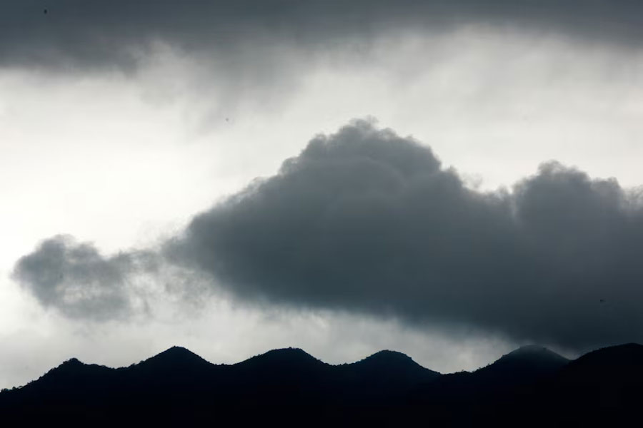 Dark clouds gather over the mountains in Zhaoqing, southern China's Guangdong province, June 27, 2005.