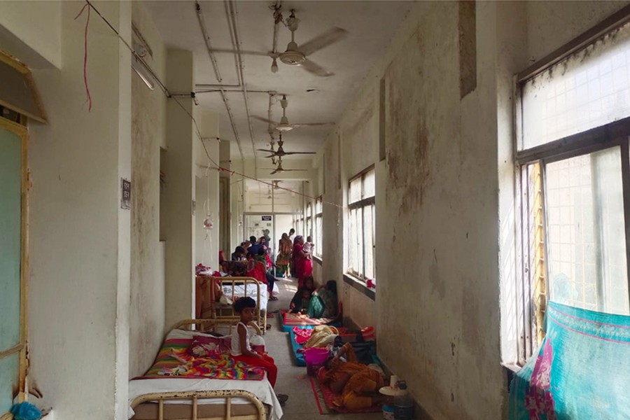 Due to unavailability of seats, patients receiving treatment straying in the balcony of Rajshahi Medical College Hospital in Rajshahi city —FE Photo