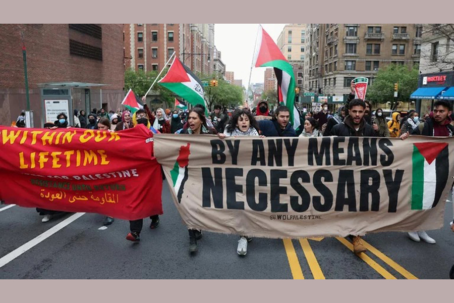Demonstrators holding a banner protest in solidarity with Pro-Palestinian organizers as they block a street, amid the ongoing conflict between Israel and the Palestinian Islamist group Hamas, in New York City, US, April 18, 2024.