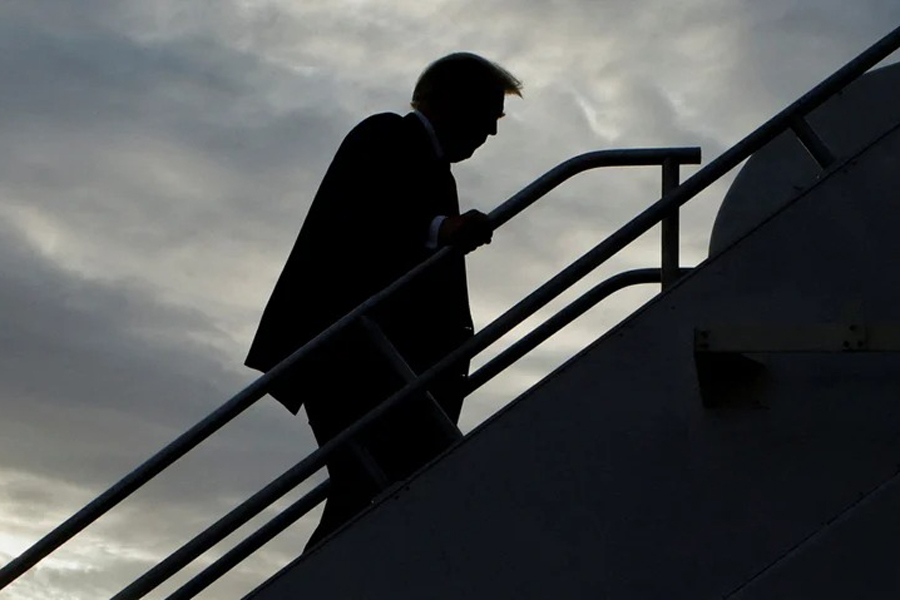 Former US President and Republican presidential candidate Donald Trump boards his plane to depart from Eastern Iowa Airport after campaigning in Cedar Rapids, Iowa, US October 7, 2023.