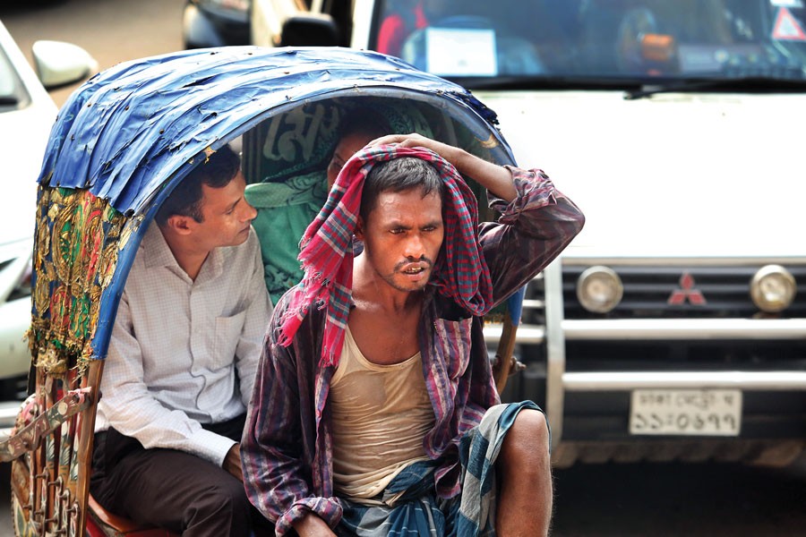 A rickshaw puller in hot summer