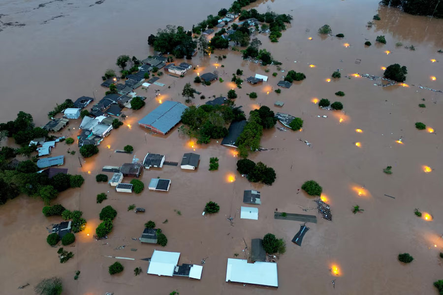 A drone view shows houses in the flooded area next to the Taquari River during heavy rains in the city of Encantado in Rio Grande do Sul, Brazil, May 1, 2024.
