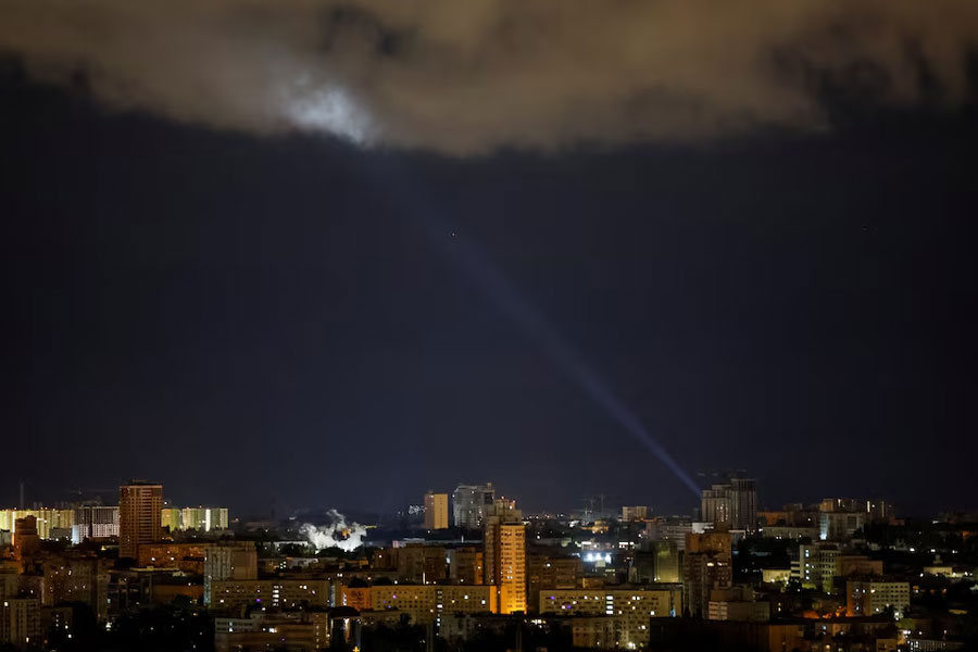 Ukrainian servicemen use a searchlight as they search for drones in the sky over the city during a Russian drone and missile strike in Kyiv, Ukraine May 8, 2024.