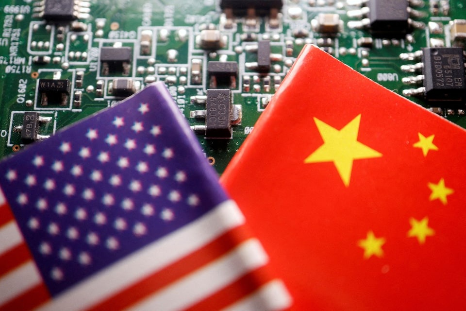Flags of China and US are displayed on a printed circuit board with semiconductor chips, in this illustration picture taken February 17, 2023.