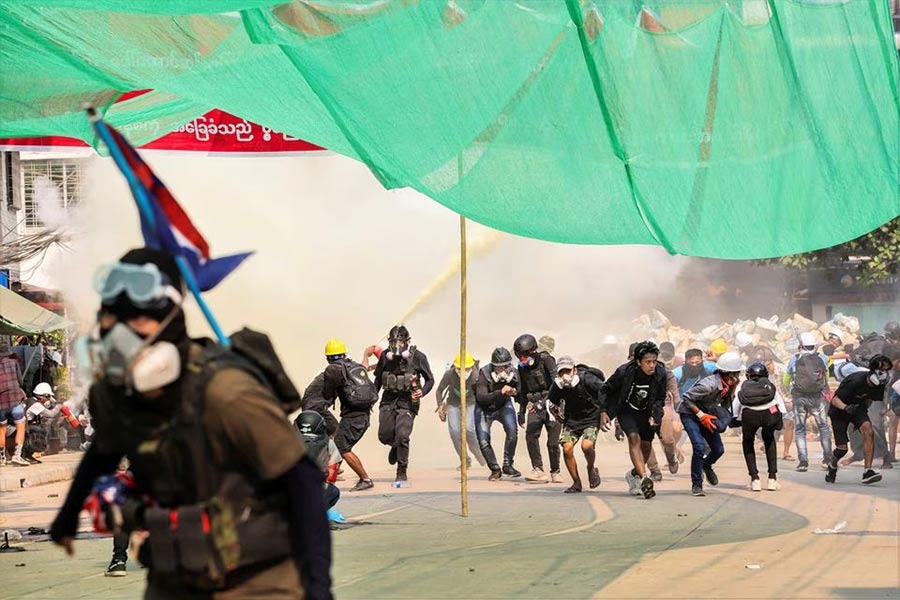 Protesters running during a crackdown of an anti-coup protests at Hlaing Township in Yangon of Myanmar in 2021 –Reuters file photo