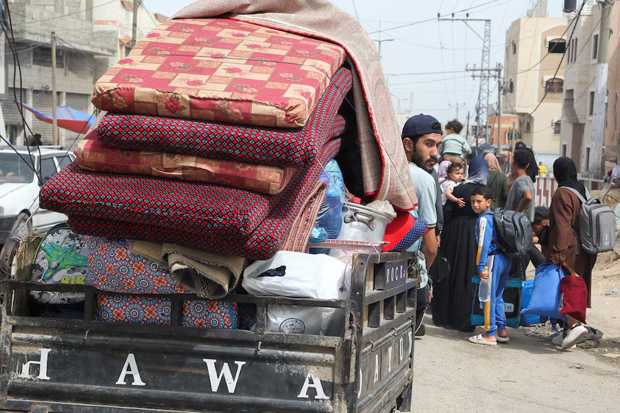 A man looks from a vehicle loaded with belongings, as Palestinians prepare to evacuate, after Israeli forces launched a ground and air operation in the eastern part of Rafah, amid the ongoing conflict between Israel and Hamas, in Rafah, in the southern Gaza Strip, May 11, 2024.