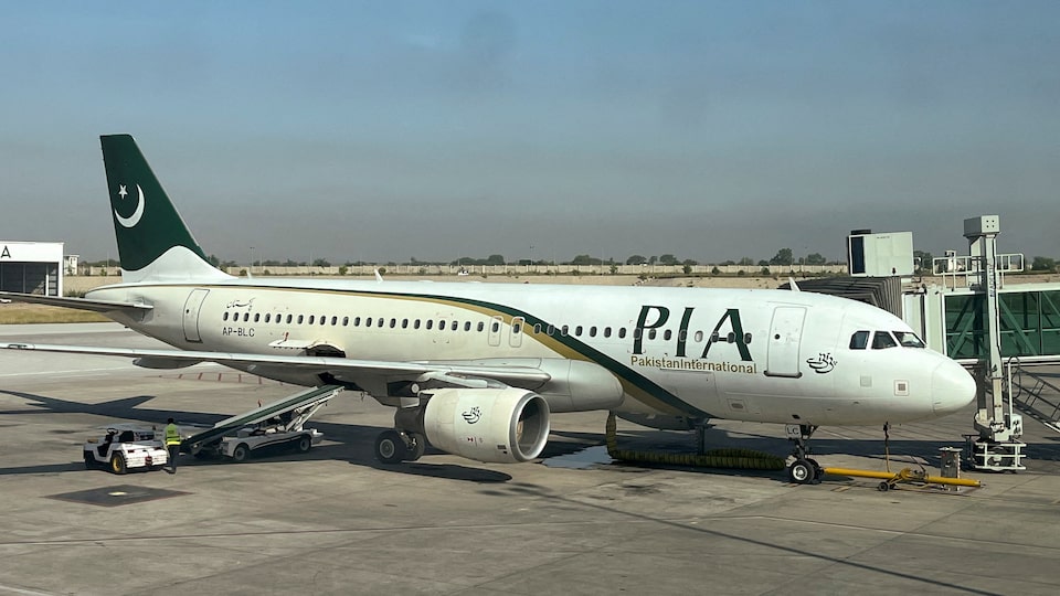 View of a Pakistan International Airlines (PIA) passenger plane, taken through a glass panel, at Islamabad International Airport, Pakistan October 3, 2023. REUTERS/Akhtar Soomro/File Photo