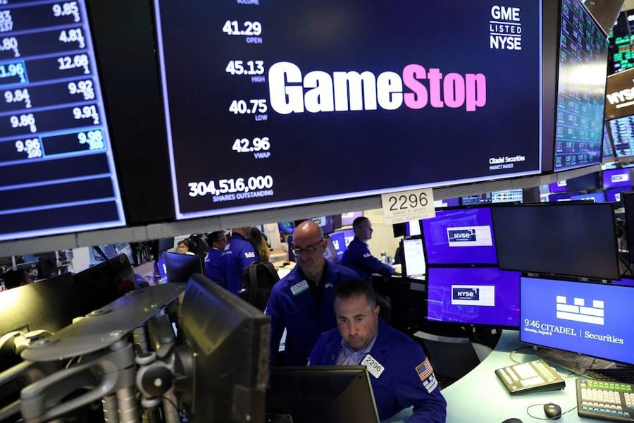 Traders work under signage for GameStop Corp. (NYSE: GME) on the trading floor at the New York Stock Exchange (NYSE) in Manhattan, New York City, US, August 8, 2022.