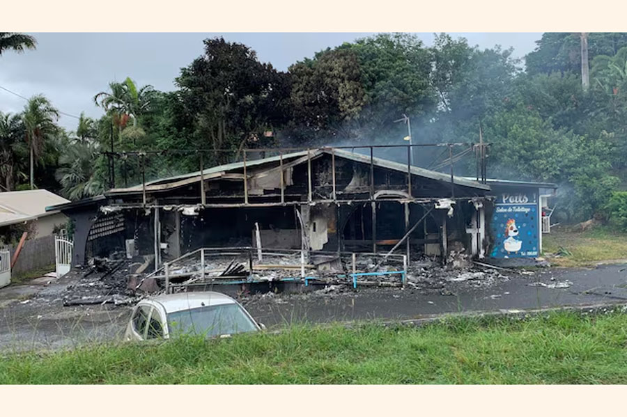 A damaged building is seen as rioters protest against plans to allow more people to take part in local elections in the French-ruled territory, which indigenous Kanak protesters reject, in Noumea, New Caledonia, May 15, 2024, in this picture obtained from social media.