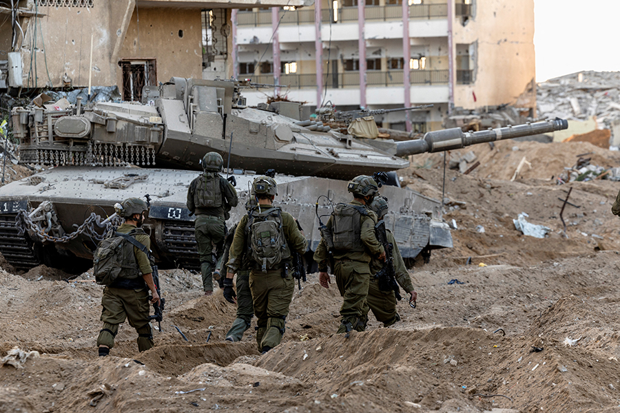 Israeli soldiers walk through rubble, amid the ongoing ground invasion against Palestinian Islamist group Hamas in the northern Gaza Strip on November 8, 2023 — Reuters/File